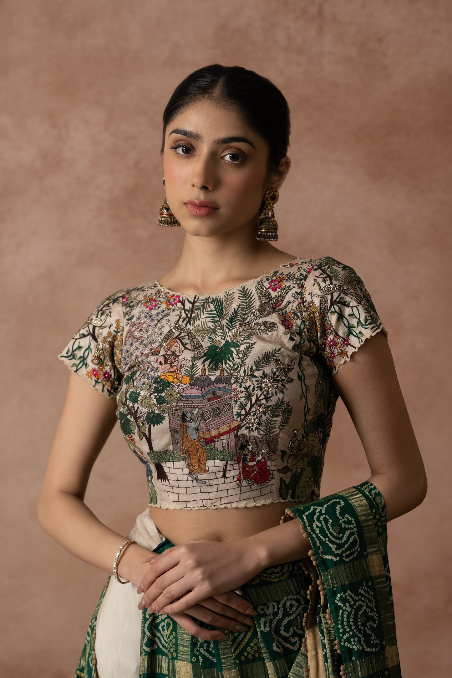 Off White Silk Blouse With Floral Lord Krishna Embroidery Paired With Organza Lehenga